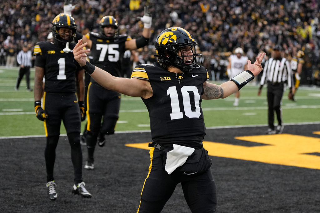 Iowa quarterback Jeremy Hecklinski (10) celebrates after a touchdown run during the second half of an NCAA college football game against Minnesota, Saturday, Oct. 25, 2025, in Iowa City, Iowa. (AP Photo/Charlie Neibergall)