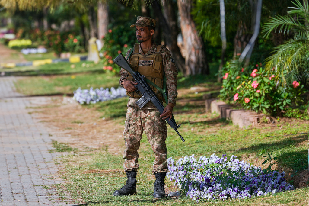 An army soldier stands guard on a roadside to ensure security ahead of the second round of negotiations between the U.S. and Iran, in Islamabad, Pakistan, Monday, April 20, 2026. (AP Photo/Anjum Naveed)