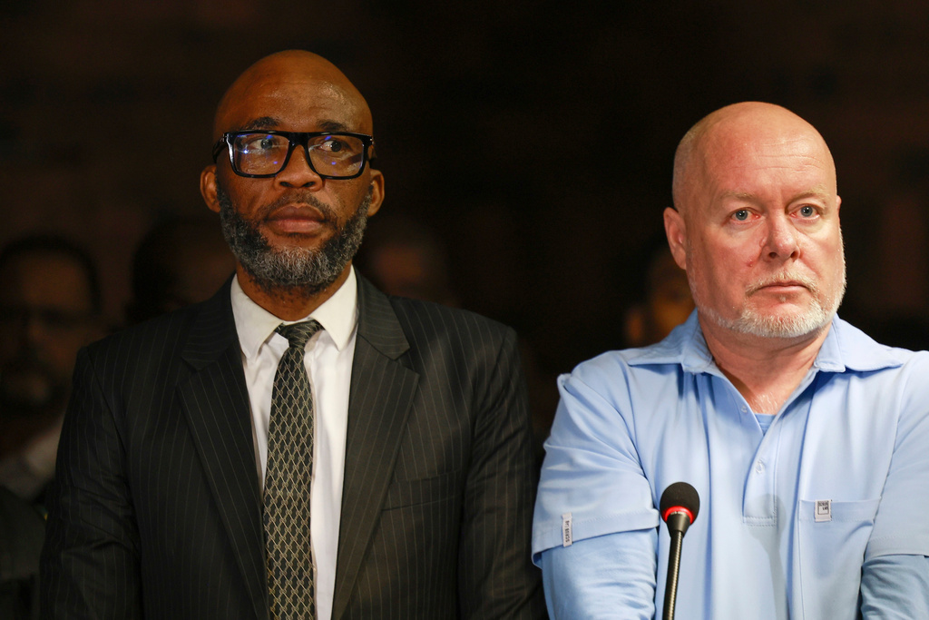 An alleged crime boss Vusimuzi "Cat" Matlala, left, with business associate, James Murray appearing at the magistrate court in Pretoria, South Africa, Wednesday, March 25, 2026, on fraud and corruption charges. (AP Photo)