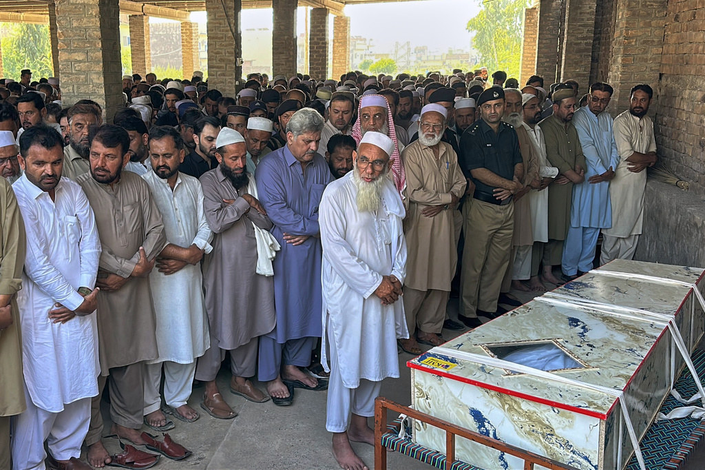 In this photo taken with a smartphone, mourners attend the funeral prayer of a victim who was killed in Friday's suicide bombing at a mosque, in Kohat, in northwestern Pakistan, Saturday, Sept. 19, 2026. (AP Photo/Maaz Awan)