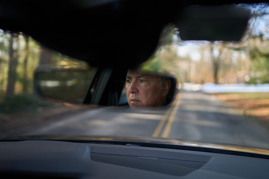 Chris Colocousis, whose retirement savings was targeted by a scammer, drives to a work meeting Wednesday, March 11, 2026, in Raynham, Mass. (AP Photo/David Goldman)