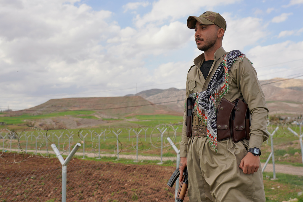 Member of the Democratic Party of Iranian Kurdistan PDKI stands at a checkpoint leading to their base in Koya district of Irbil, Iraq, Friday, Feb. 27, 2026. (AP Photo/Rashid Yahya)