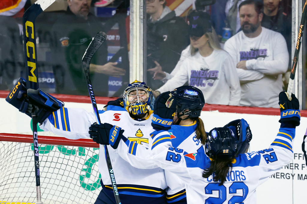 Toronto Sceptres goalie Raygan Kirk, left, celebrates with teammates after defeating the Ottawa Charge in a PWHL hockey game in Calgary, Alberta, Wednesday, April 1, 2026. (Larry MacDougal/The Canadian Press via AP)
