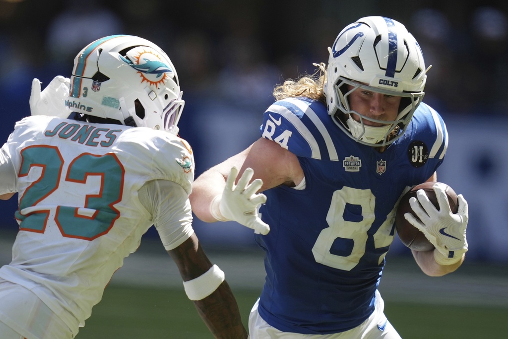 Indianapolis Colts tight end Tyler Warren (84) is stopped by Miami Dolphins Jack Jones during the second half of an NFL football game Sunday, Sept. 7, 2025, in Indianapolis. (AP Photo/Darron Cummings)