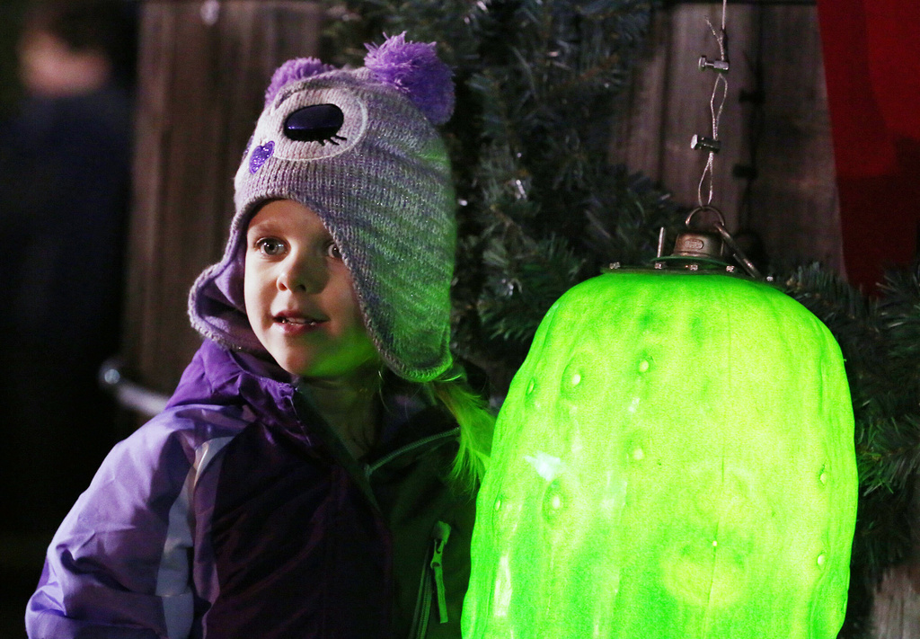 FILE - Sarah Searcy, 4, poses with the ceremonial pickle at the New Year's Eve Pickle Drop in Mount Olive, N.C., Wednesday night, Dec. 31, 2014. (Casey Mozingo/The Goldsboro News-Argus via AP, File)