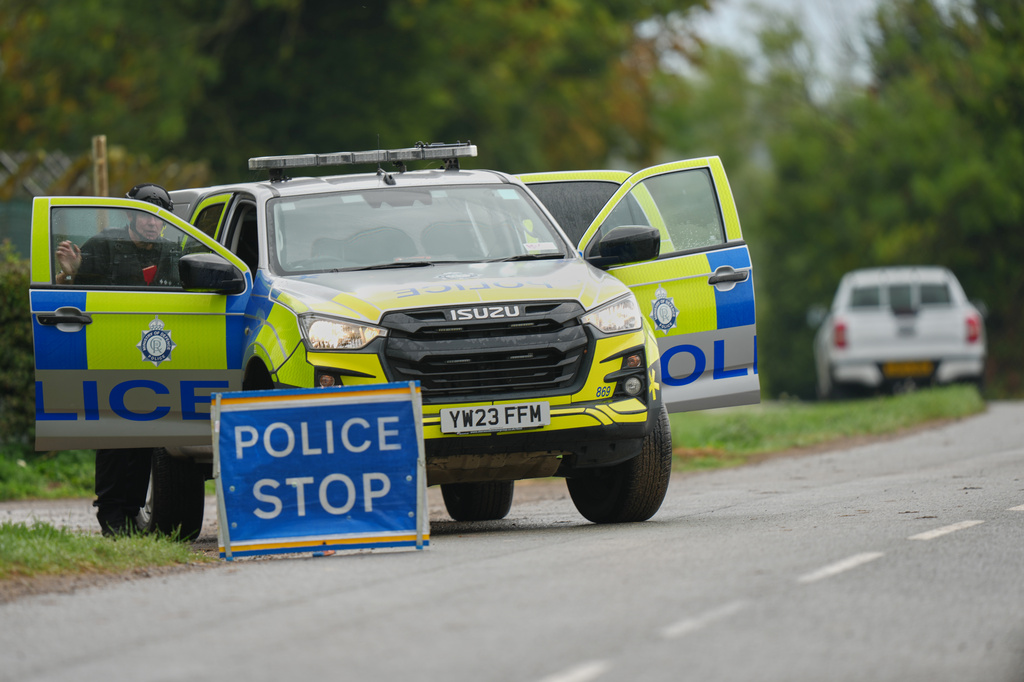 Police guard a road leading to RAF Fairford, a US Airbase, after an incident in Fairford, England , Sunday, Sept. 27, 2026. (AP Photo/Alastair Grant)