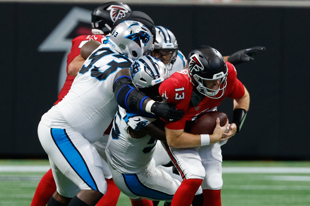 Atlanta Falcons quarterback Cooper Rush (13) is sacked during an NFL football game in Atlanta, Sunday, Sept. 20, 2026. (AP Photo/Erik S. Lesser)