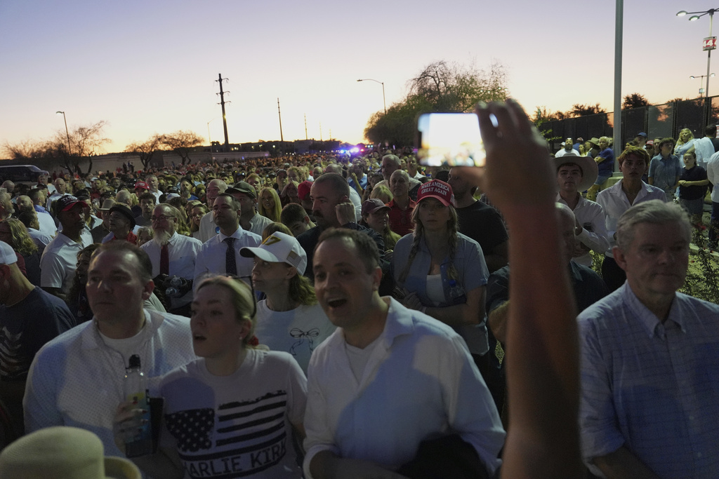 People wait in line before a memorial for conservative activist Charlie Kirk Sunday, Sept. 21, 2025, at State Farm Stadium in Glendale, Ariz. (AP Photo/Jae C. Hong)