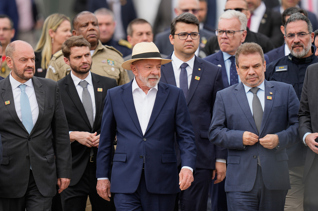 Brazilian President Luiz Inacio Lula da Silva, center, arrives for a ceremony to announce a new security plan to combat organized crimes in Rio de Janeiro, Friday, Sept. 18, 2026. (AP Photo/Silvia Izquierdo)