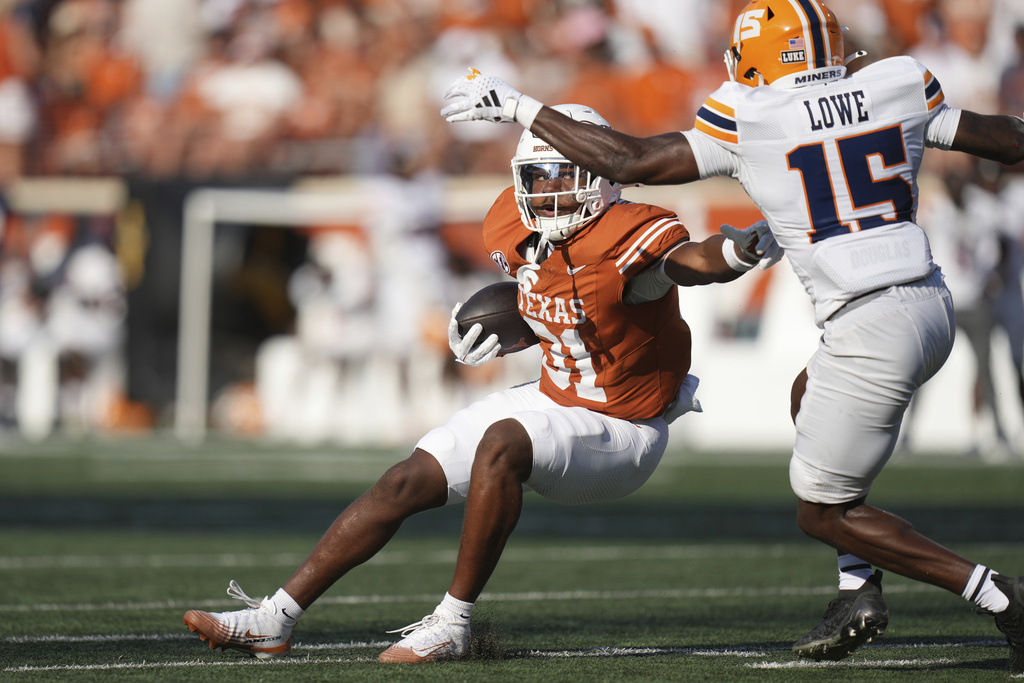 Texas running back James Simon (31) runs against UTEP safety Kode Lowe (15) during the second half of an NCAA college football game in Austin, Texas, Saturday, Sept. 13, 2025. (AP Photo/Eric Gay)