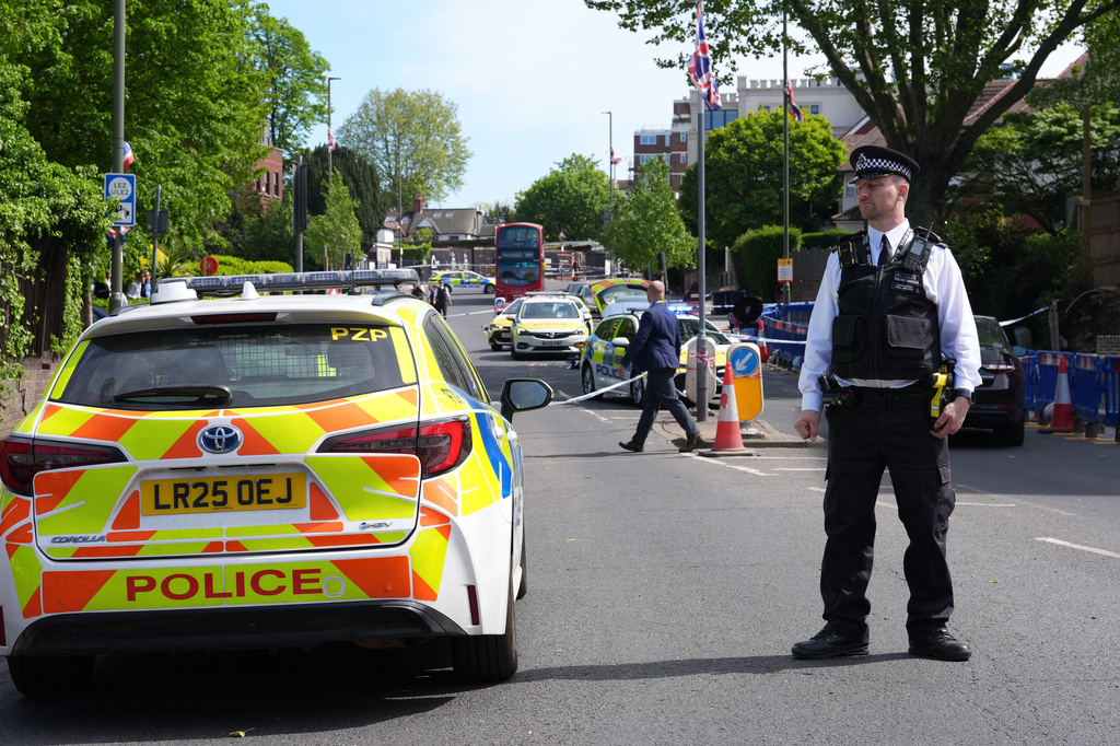 A police officer stands at the scene where two people were stabbed, in Golders Green neighborhood, that has a large Jewish community, in London, Wednesday April 29, 2026. (Lucy North/PA via AP)