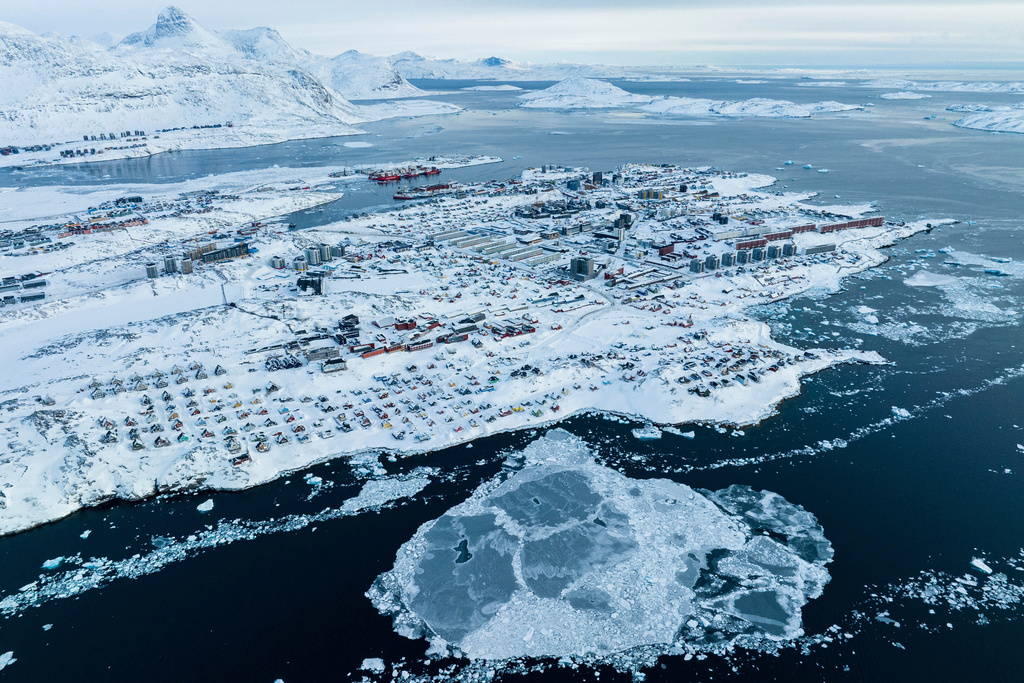 FILE - Houses covered by snow are seen on the coast of a sea inlet of Nuuk, Greenland, on March 7, 2025. (AP Photo/Evgeniy Maloletka, File)