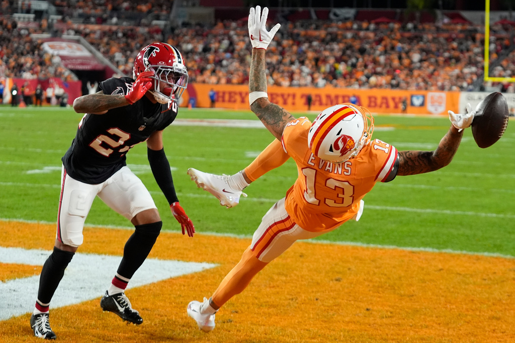 Tampa Bay Buccaneers wide receiver Mike Evans (13) misses the catch Atlanta Falcons cornerback A.J. Terrell Jr. (24) during the first half of an NFL football game, Thursday, Dec. 11, 2025, in Tampa, Fla. (AP Photo/Chris O'Meara)