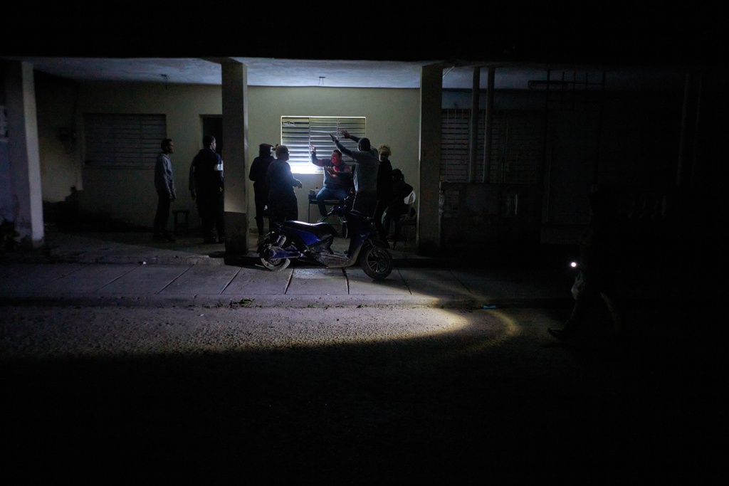 People celebrate a birthday during a scheduled power outage in Santa Cruz del Norte, home to one of Cuba’s largest thermoelectric plants, late Tuesday, Feb. 3, 2026. (AP Photo/Ramon Espinosa)