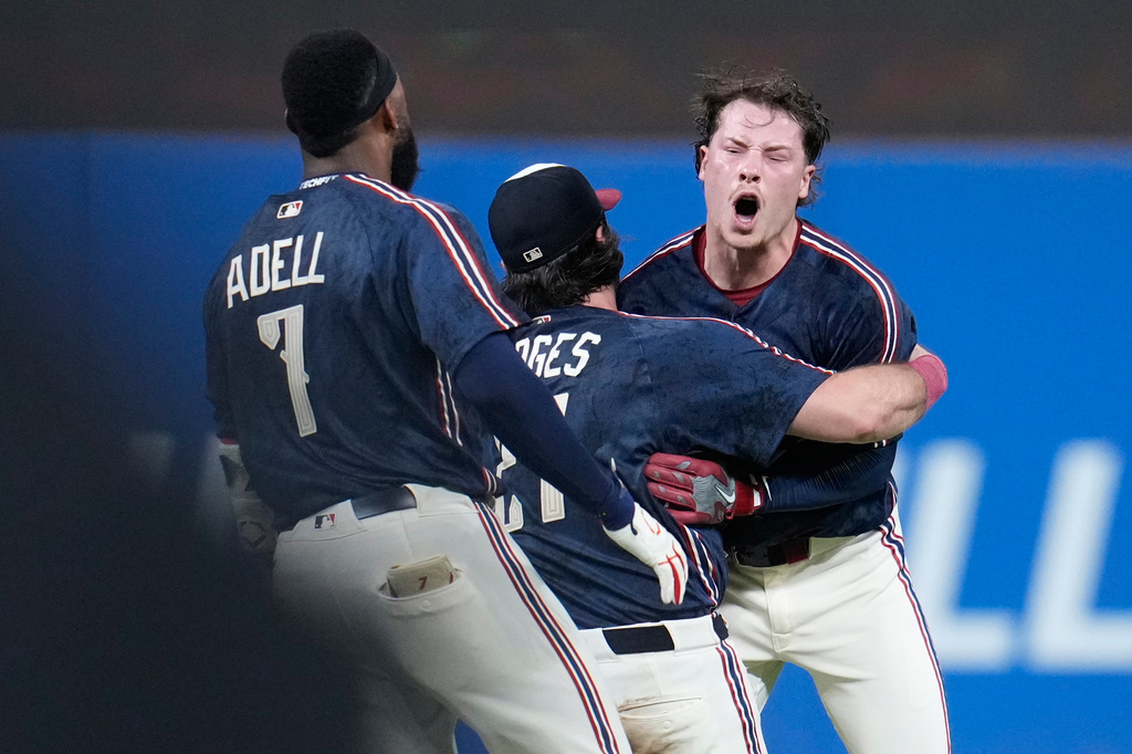 Cleveland Guardians' Travis Bazzana, right, celebrates with teammates after his game winning single in the tenth inning of the second baseball game of a split doubleheader against the Detroit Tigers in Cleveland, Friday, Sept. 4, 2026. (AP Photo/Sue Ogrocki)