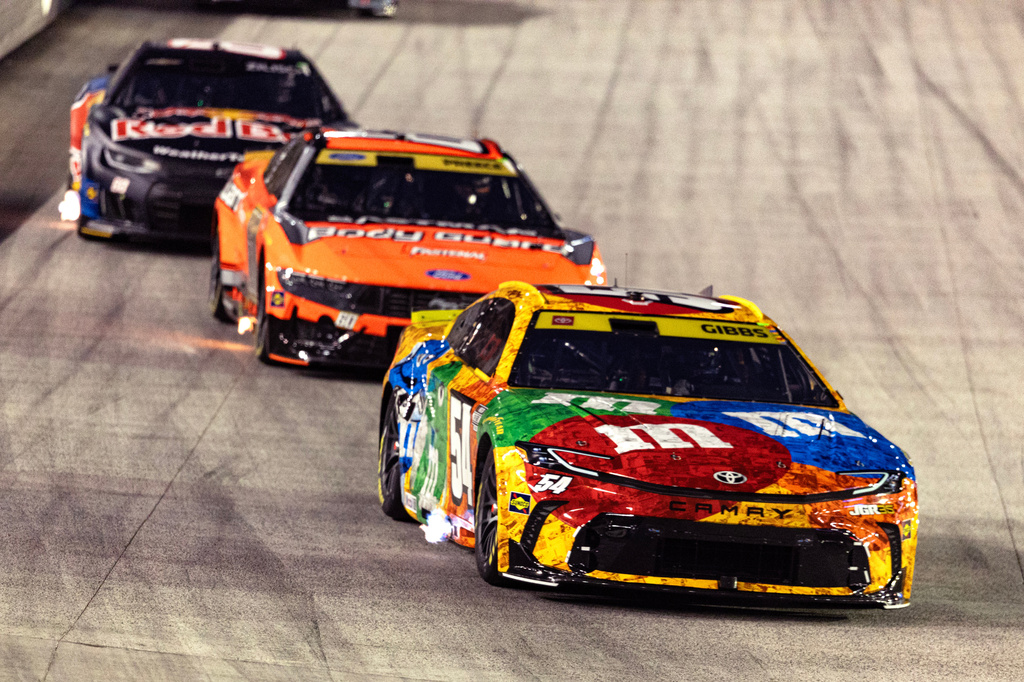 Ty Gibbs (54), in the throwback M&M's car honoring the late Kyle Busch, leads Ryan Preece and Connor Zilisch during a NASCAR Cup Series auto race Saturday, Sept. 19, 2026, in Bristol, Tenn. (AP Photo/Wade Payne)