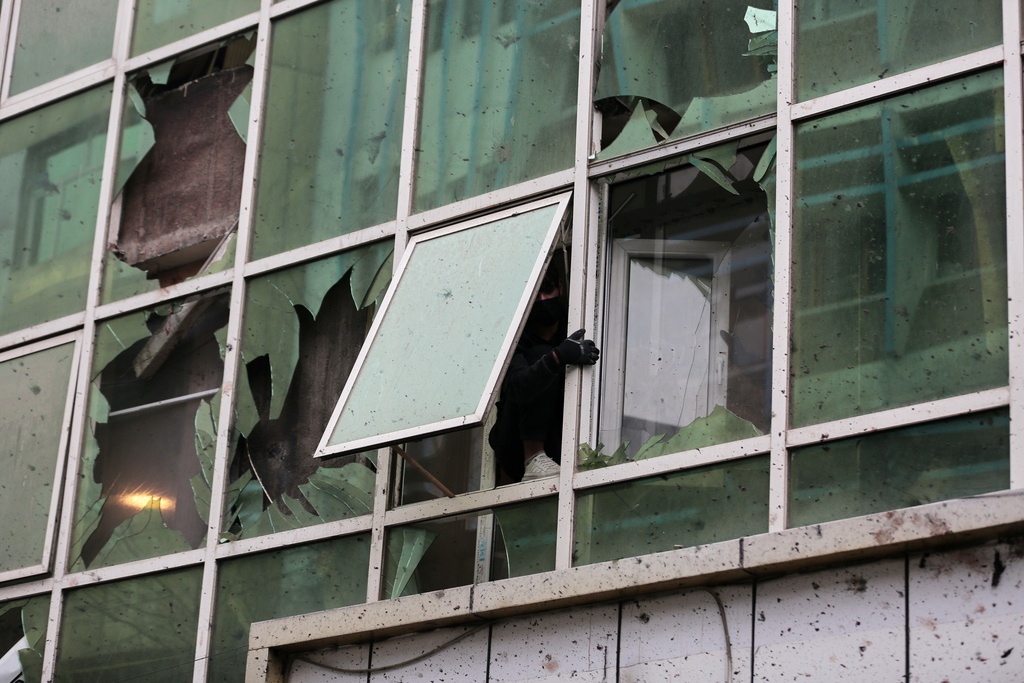 Damage to a building across the street is seen a day after an explosion at a Chinese restaurant killed at least seven people, including a Chinese national, in Kabul, Afghanistan, Tuesday, Jan. 20, 2026. (AP Photo/Siddiqullah Alizai)