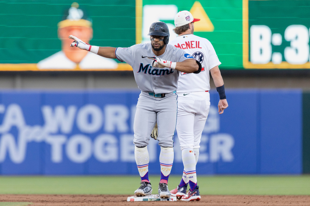 Miami Marlins' Otto Lopez celebrates an RBI double during the fifth inning of a baseball game against the Athletics Saturday, July 4, 2026, in West Sacramento, Calif. (AP Photo/Sara Nevis)