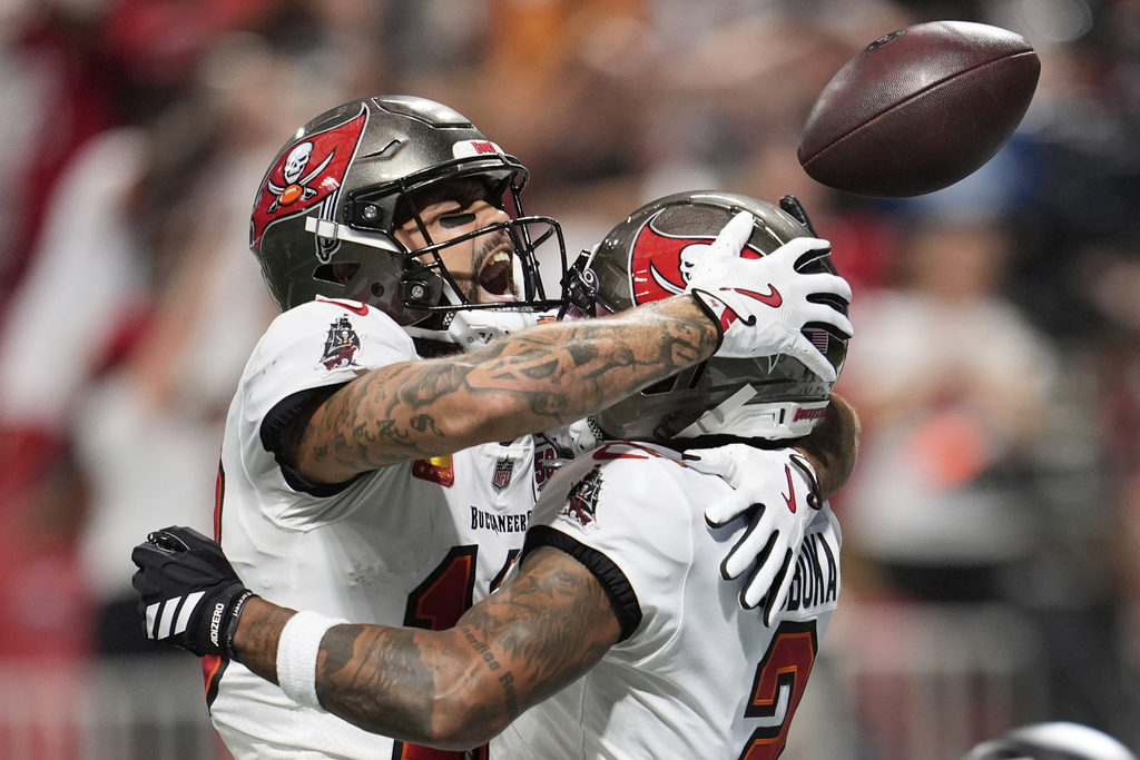 Tampa Bay Buccaneers wide receiver Mike Evans (13) celebrates with Tampa Bay Buccaneers wide receiver Emeka Egbuka (2) after Egbuka's touchdown during the second half of an NFL football game, Sunday, Sept. 7, 2025, in Atlanta. (AP Photo/Mike Stewart)