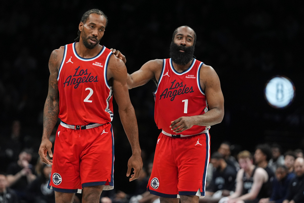 LA Clippers' James Harden (1) talks to Kawhi Leonard (2) during the second half of an NBA basketball game against the Brooklyn Nets Friday, Jan. 9, 2026, in New York. (AP Photo/Frank Franklin II)