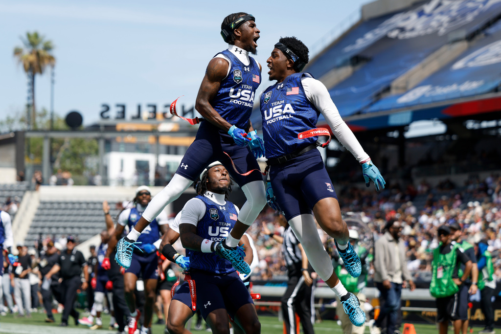 U.S. National Flag team's Isaiah Calhoun celebrates with teammate Shawn Theard Jr. the Fanatics Flag Football Classic against the Wildcats FFC, Saturday, March 21, 2026, in Los Angeles. (AP Photo/Caroline Brehman)