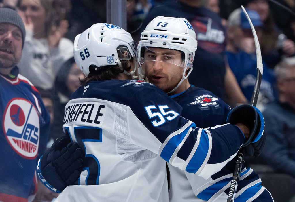 Winnipeg Jets' Gabriel Vilardi (13) celebrates his goal against the Vancouver Canucks with Mark Scheifele (55) during the second period of an NHL hockey game in Vancouver, B.C., on Wednesday, Feb. 25, 2026. (Ethan Cairns/The Canadian Press via AP)