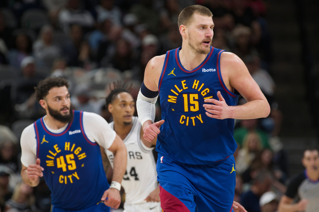 Denver Nuggets center Nikola Jokic (15) runs up court during the first half of an NBA basketball game against the San Antonio Spurs, Sunday, April 12, 2026, in San Antonio. (AP Photo/Darren Abate)
