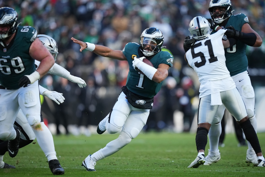 Philadelphia Eagles quarterback Jalen Hurts (1) runs with the ball during the second half of an NFL football game against the Las Vegas Raiders on Sunday, Dec. 14, 2025, in Philadelphia. (AP Photo/Matt Slocum)