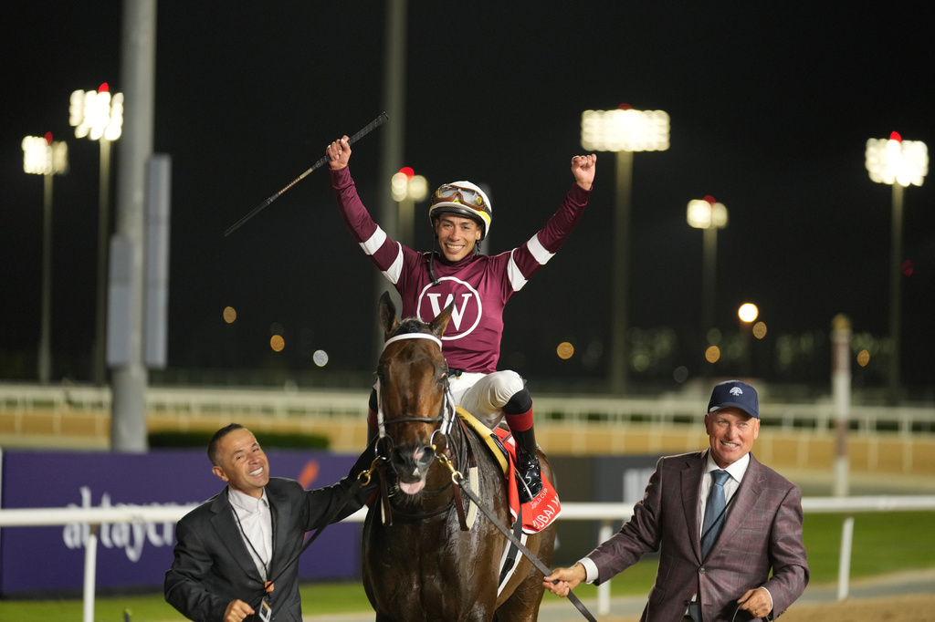 Jockey Jose Ortiz, aboard Magnitude, celebrates winning the $12 million Dubai World Cup horse race over 2000m (10 furlongs) at Meydan Racecourse in Dubai, the United Arab Emirates, Saturday, March 28, 2026. (AP Photo/Altaf Qadri)