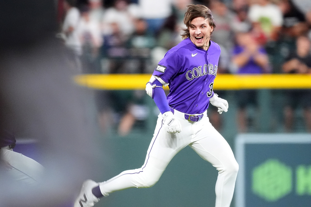 Colorado Rockies' Jake McCarthy celebrates after his three-run walkoff triple off Boston Red Sox relief pitcher Aroldis Chapman in the ninth inning of a baseball game Monday, June 22, 2026, in Denver. (AP Photo/David Zalubowski)