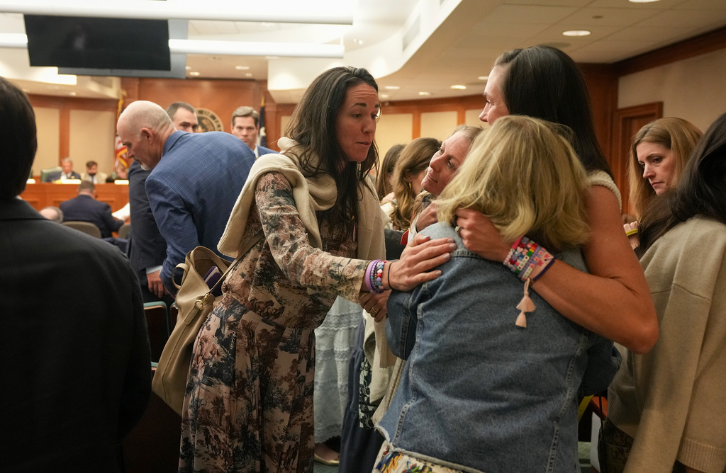CiCi Steward, left, whose 8-year-old daughter, Cile Steward, died in the July 4, 2025, flood at Camp Mystic, gathers with other mothers after a joint House and Senate flood investigating committee hearing at the Capitol in Austin, Texas, Tuesday April 28, 2026. (Jay Janner/Austin American-Statesman via AP)