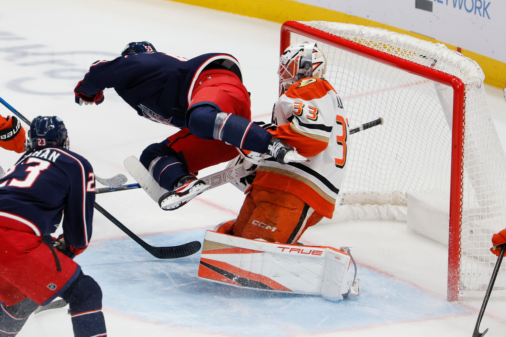 Columbus Blue Jackets' Yegor Chinakhov, left, interferes with Anaheim Ducks' Ville Husso during the third period of an NHL hockey game, Tuesday, Dec. 16, 2025, in Columbus, Ohio. Chinakhov was penalized on the play. (AP Photo/Jay LaPrete)