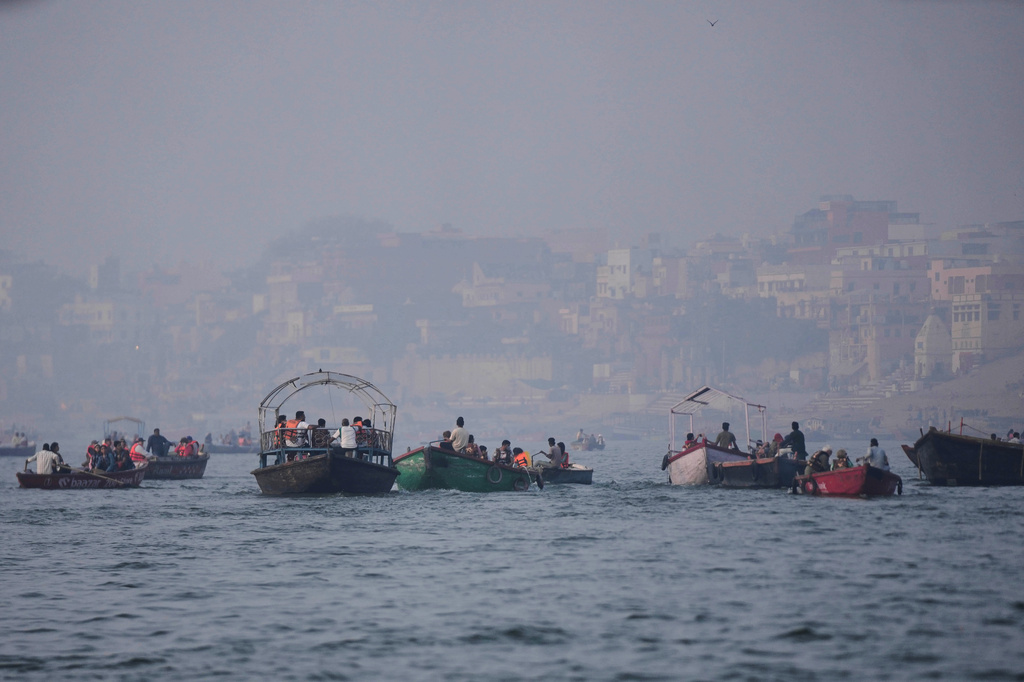 FILE - Tourists take a boat ride early morning in the Ganges river in Varanasi, India, March.16, 2026. (AP Photo/Channi Anand, File)