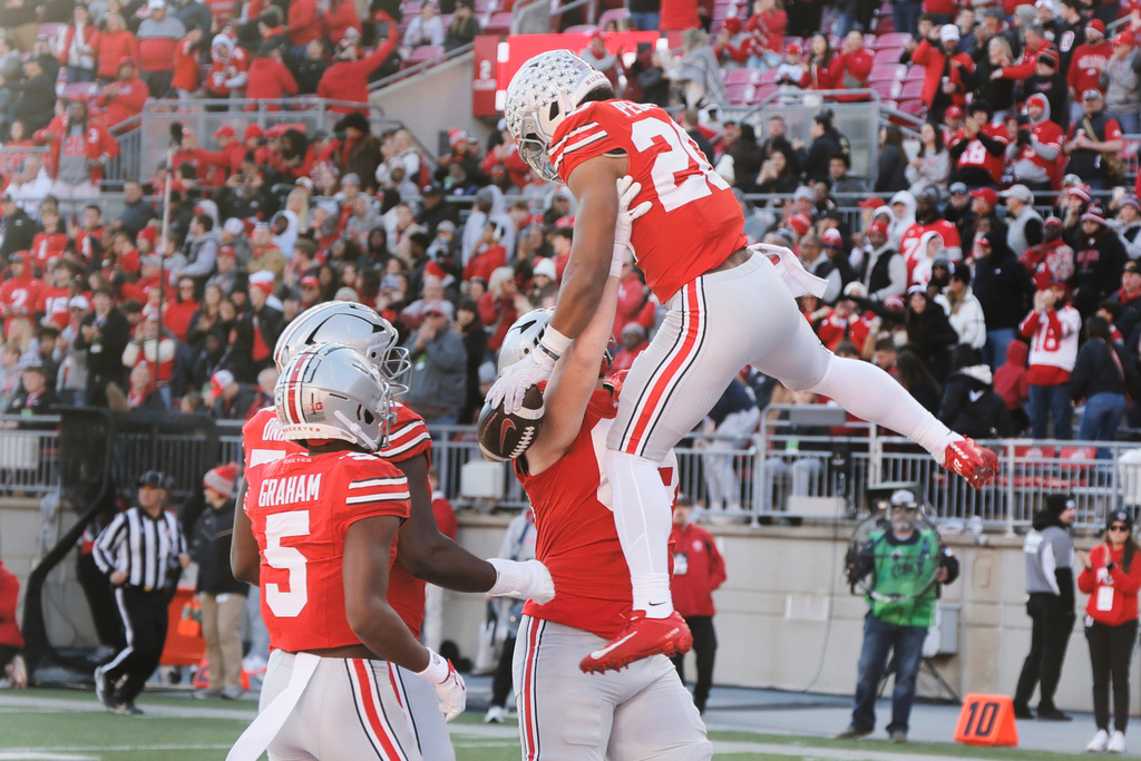 Ohio State running back James Peoples, top, celebrates with teammates after scoring a touchdown against Rutgers during the second half of an NCAA college football game, Saturday, Nov. 22, 2025, in Columbus, Ohio. (AP Photo/Jay LaPrete)