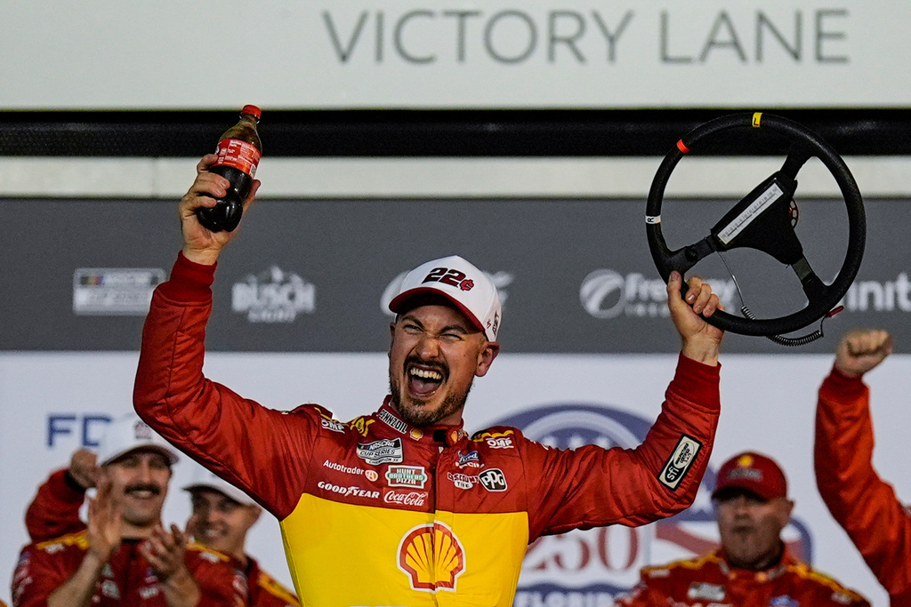Joey Logano and crew celebrate a win in Victory Lane during the first of two NASCAR Daytona 500 qualifying auto races at Daytona International Speedway, Thursday, Feb. 12, 2026, in Daytona Beach, Fla. (AP Photo/Mike Stewart)