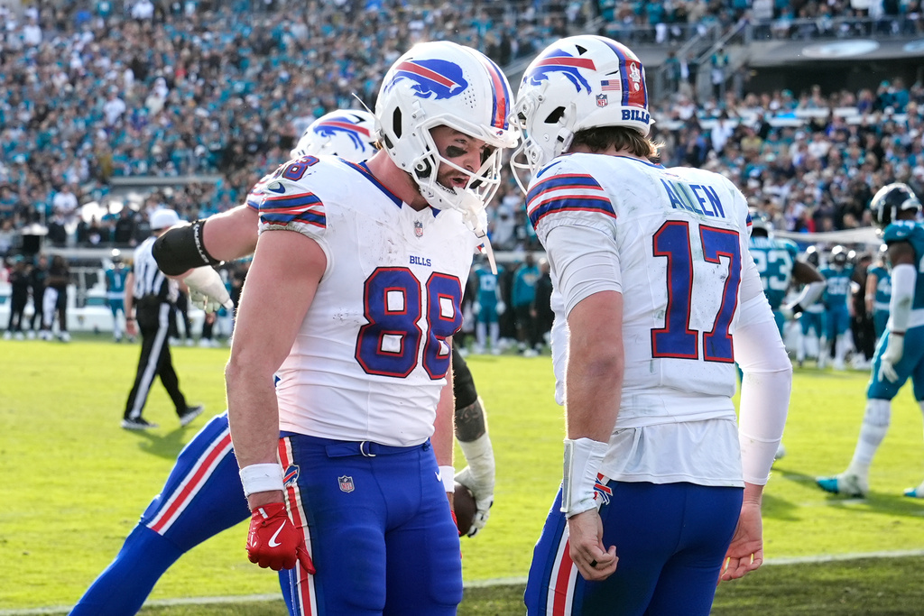 Buffalo Bills quarterback Josh Allen (17) celebrates his touchdown with tight end Dawson Knox (88) during the second half of an NFL wild-card playoff football game against the Jacksonville Jaguars Sunday, Jan. 11, 2026, in Jacksonville, Fla. (AP Photo/Chris O'Meara)