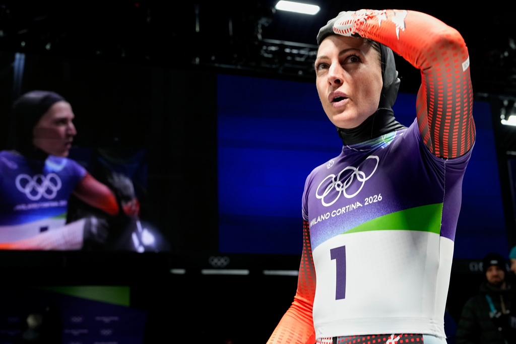 Austria's Janine Flock arrives at the finish during a women's skeleton run at the 2026 Winter Olympics, in Cortina d'Ampezzo, Italy, Friday, Feb. 13, 2026. (AP Photo/Alessandra Tarantino)