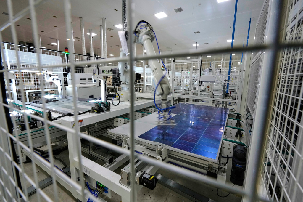 FILE - A robot places solar cells on a glass panel at a ReNew manufacturing plant on the outskirts of Jaipur, India, Aug. 21, 2025. (AP Photo/Manish Swarup, File)