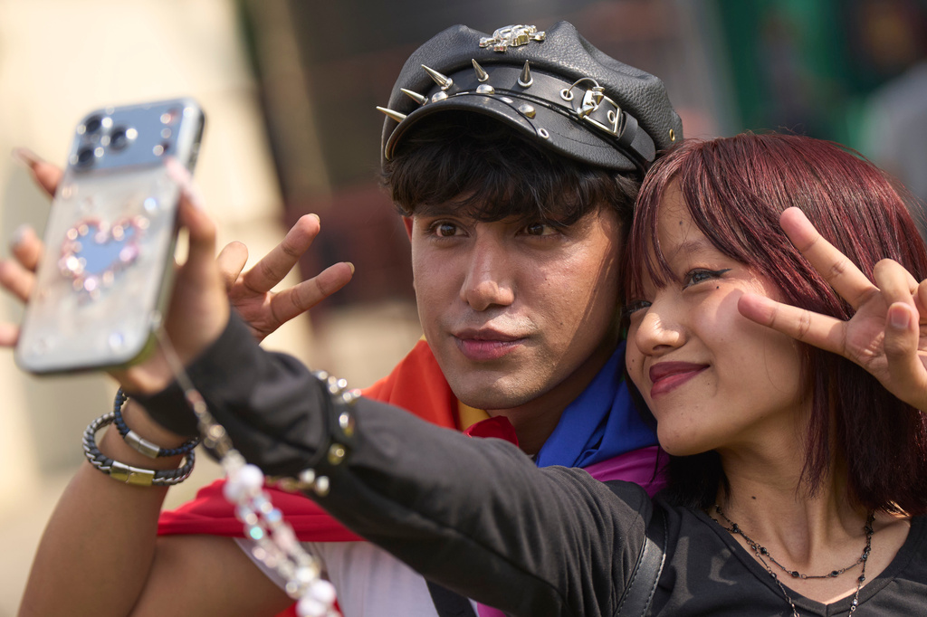 Participants take selfie as members of the LGBTQ+ community and supporters take out a Pride Month rally in Kathmandu, Nepal, on Saturday, June 13, 2026. (AP Photo/Niranjan Shrestha)
