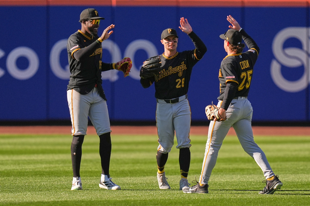 Pittsburgh Pirates outfielders Oneil Cruz, left, Jake Mangum, center, and Billy Cook celebrate after a baseball game against the New York Mets, Sunday, March 29, 2026, in New York. (AP Photo/Seth Wenig)