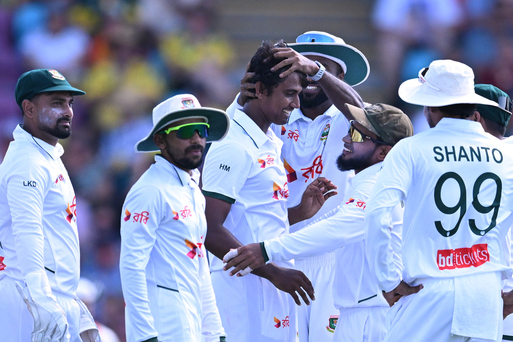 Bangladesh's Hasan Mahmud, center, is congratulated by teammates after taking the wicket of Australia's Steve Smith during their cricket test match in Darwin, Australia, Thursday, Aug. 13, 2026. (James Ross/AAP Image via AP)