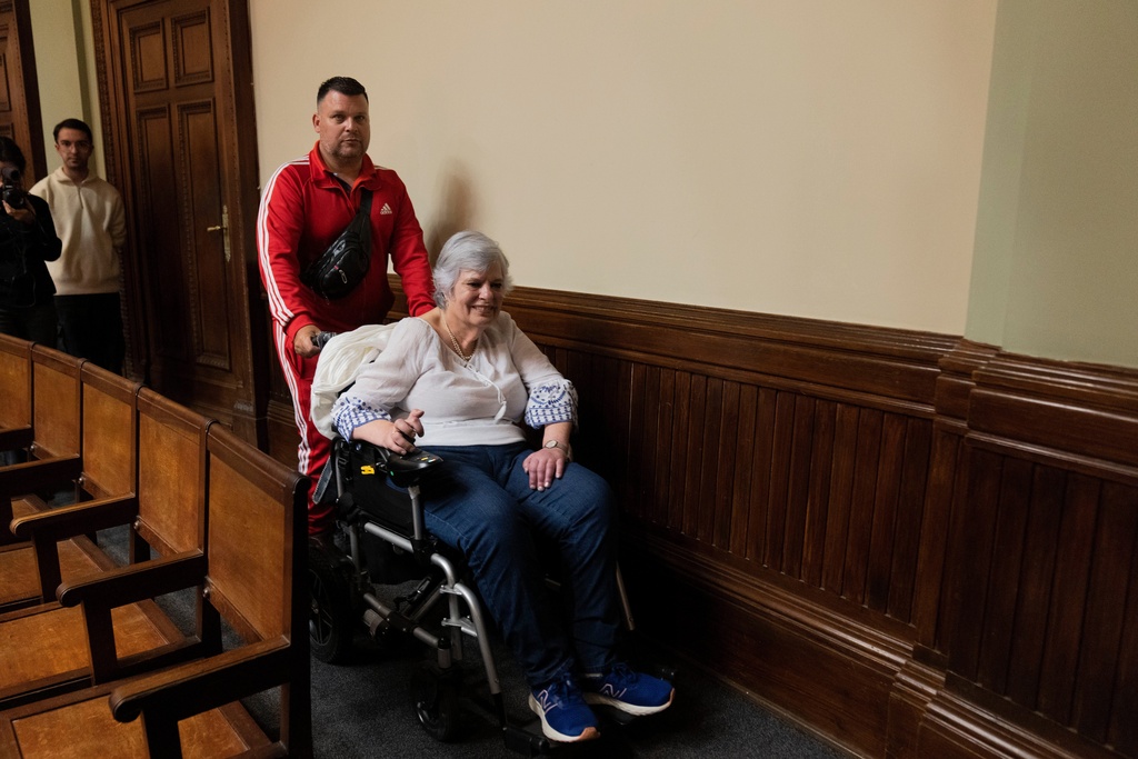Beatriz Gelos, a woman suffering amyotrophic lateral sclerosis (ALS) leaves the Senate after attending part of a session on a bill to legalize euthanasia, which was approved by the lower house, in Montevideo, Uruguay, Wednesday, Oct. 15, 2025. (AP Photo/Matilde Campodonico)