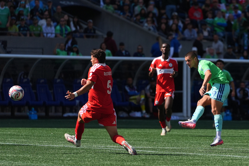 Seattle Sounders forward Dejan Joveljic, right, scores a goal past Chicago Fire FC defender Sam Rogers (5) during the second half of an MLS soccer match, Saturday, Aug. 29, 2026, in Seattle. (AP Photo/Lindsey Wasson)