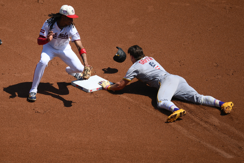 Pittsburgh Pirates' Konnor Griffin (6) steals second base against Washington Nationals shortstop CJ Abrams, left, during the first inning of a baseball game, Saturday, July 4, 2026, in Washington. (AP Photo/Nick Wass)