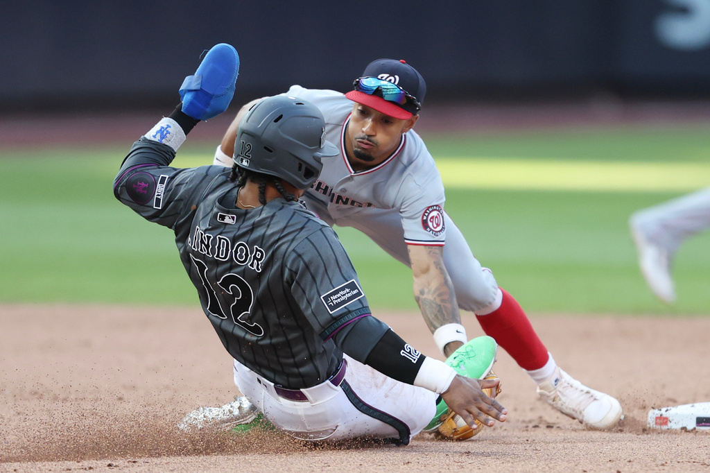New York Mets' Francisco Lindor (12) is tagged out at second base by Washington Nationals second baseman Nasim Nuñez during the eighth inning of a baseball game, Saturday, Aug. 15, 2026, in New York. (AP Photo/Heather Khalifa)