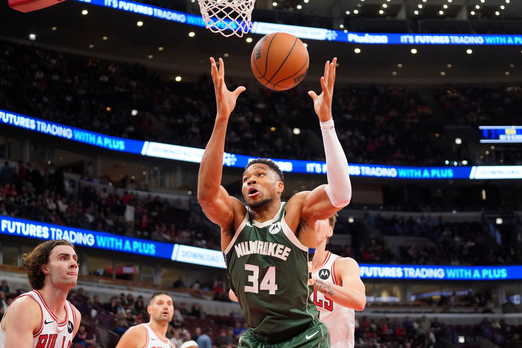 Milwaukee Bucks forward Giannis Antetokounmpo (34) grabs a rebound against the Chicago Bulls during the first half of a preseason NBA basketball game Sunday, Oct. 12, 2025, in Chicago. (AP Photo/David Banks)