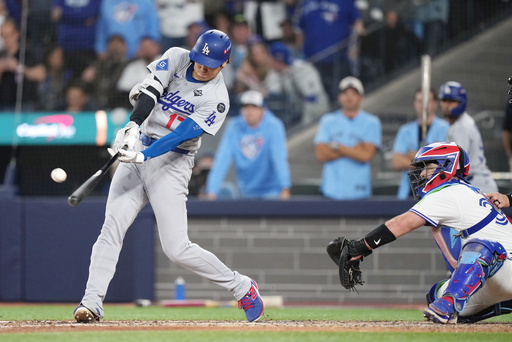 Los Angeles Dodgers' Shohei Ohtani (17) hits a two-run home run against the Toronto Blue Jays during the sixth inning in Game 1 of baseball's World Series, Friday, Oct. 24, 2025, in Toronto. (Nathan Denette/The Canadian Press via AP) Los Angeles Dodgers' Shohei Ohtani (17) hits a two-run home run against the Toronto Blue Jays during the sixth inning in Game 1 of baseball's World Series, Friday, Oct. 24, 2025, in Toronto. (Nathan Denette/The Canadian Press via AP)