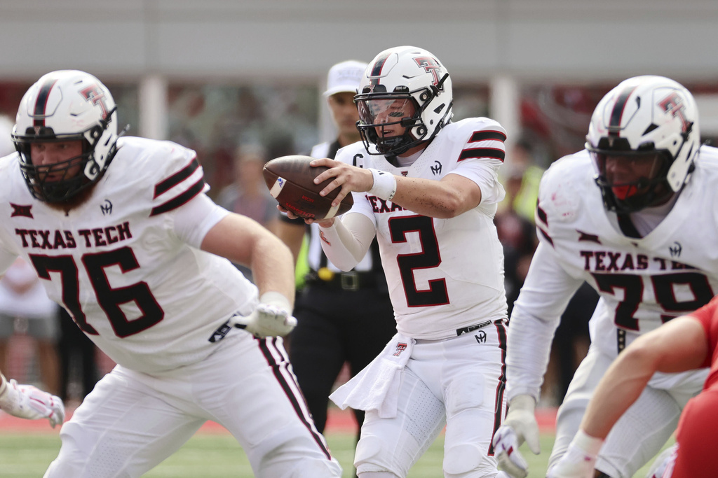 Texas Tech quarterback Behren Morton takes a snap during the first half of an NCAA college football game against Utah, Saturday, Sept. 20, 2025, in Salt Lake City, Utah. (AP Photo/Jeffrey D. Allred)