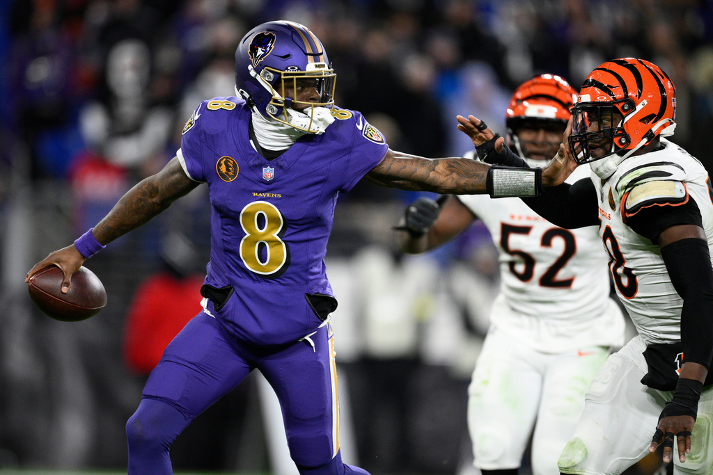 Baltimore Ravens quarterback Lamar Jackson (8) is pressured by Cincinnati Bengals defensive end Joseph Ossai (58) during the second half of an NFL football game, Thursday, Nov. 27, 2025, in Baltimore. (AP Photo/Nick Wass)