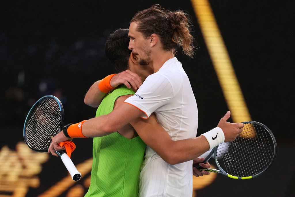 Carlos Alcaraz of Spain is congratulated by Alexander Zverev, right, of Germany following their semifinal match at the Australian Open tennis championship in Melbourne, Australia, Friday, Jan. 30, 2026. (AP Photo/Dita Alangakra)